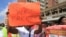 FILE: Zimbabwean workers demonstrate against the high cost of living and low wages in Harare, Saturday, April, 11, 2015. ( AP Photo/Tsvangirayi Mukwazhi)