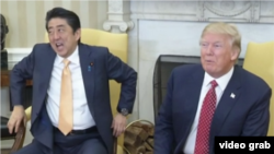 At the end of a long handshake with President Donald Trump in the Oval Office at the White House, Japanese Prime Minister Shinzo Abe planted his hands into the armrests of his chair as he looked away, Feb. 10, 2017.