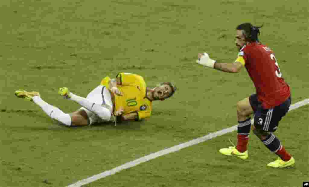 Brazil's Neymar, left, cries in pain after making contact with Colombia's Mario Yepes during the World Cup quarterfinal soccer match between Brazil and Colombia at the Arena Castelao in Fortaleza, Brazil, Friday, July 4, 2014. (AP Photo/Themba Hadebe)