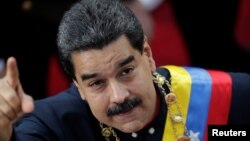 Venezuela's President Nicolas Maduro gestures as he arrives for a session of the National Constituent Assembly at Palacio Federal Legislativo in Caracas, Venezuela, Aug. 10, 2017.