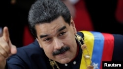 FILE - Venezuela's President Nicolas Maduro gestures as he arrives for a session of the National Constituent Assembly at Palacio Federal Legislativo in Caracas, Venezuela, Aug. 10, 2017.