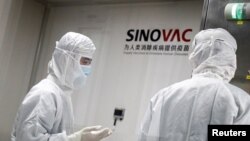 People work in a laboratory of Chinese vaccine maker Sinovac Biotech, developing an experimental COVID-19 vaccine, during a government-organized media tour in Beijing, China, Sep. 24, 2020.