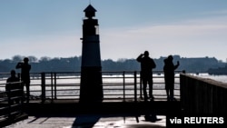 Warga menikmati suhu yang hangat pada musim dingin di pelabuhan Malmo, Swedia (foto: dok). 