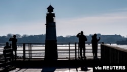 People enjoy a sunny winter Sunday in the Western Harbour of Malmo, Sweden February 14, 2021.