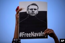 Seorang perempuan memegang plakat "Bebaskan Navalny" selama protes terhadap pemenjaraan Rusia terhadap pemimpin oposisi Alexei Navalny, di Tel Aviv, Israel, Rabu, April. 21, 2021 (Foto: AP)