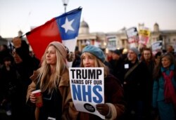 Protesters hold a placard at a demonstration during U.S. President Donald Trump's visit for NATO summit, in London, Dec. 3, 2019.