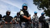 FILE - U.N. peacekeepers stand guard at an internally displaced persons camp at an UNMISS base in Juba, South Sudan, May 6, 2014. An advance team of peacekeepers arrived in Juba on Monday. They are to be followed by 4,000 more in June or July.