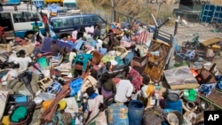 FILE - Civilians who fled recent fighting stack their belongings up outside the gate of the United Nations Mission compound in South Sudan (UNMISS).