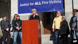 Consumer advocate Erin Brockovich, who famously took on Pacific Gas & Electric Co. in the 1990s, stands with wildfire victims and speaks outside the state Capitol in Sacramento, Calif., Jan. 22, 2019.