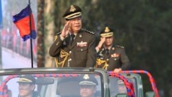 FILE - Cambodian Prime Minister Hun Sen (L) salutes, along with his son, Lt. Gen. Hun Manet (background) during an inspection of troops at a ceremony in Phnom Penh, Cambodia, Jan. 24, 2019. (Handout via AFP)