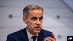 FILE - Mark Carney speaks during the Bank of England interest rate decision and inflation report press conference at the Bank of England in London, Aug. 1, 2019. 