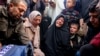 Family and relatives mourn over the body of Palestinian journalist Ahmed Al-Shayah, covered with a press vest, after he was killed during an Israeli strike the previous night in Khan Yunis, at Nasser Hospital, in the southern Gaza Strip, on January 16, 20