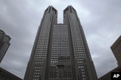 FILE - The Tokyo Metropolitan Government Office building soars in Tokyo, on June 15, 2016. Called “Tokyo Futari Story,” the city hall online site is an effort to create couples, or “futari." (AP Photo/Shuji Kajiyama, File)