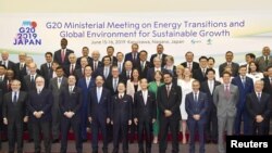 Ministers and delegates gather for a family photo session at G20 energy and environment ministers meeting in Karuizawa, Japan, June 15, 2019, in this photo taken by Kyodo. 