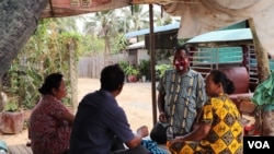 Hy Sokhom pictured with his family, as they gather at their home in Kien Svay district, Kandal province, Cambodia, April 12, 2020.