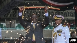 (FILES) Kenyan President William Ruto lifts a sword at the Moi International Sports Center Kasarani in Nairobi, Kenya on September 13, 2022 during the inauguration ceremony.
