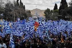FILE - Protesters take part in a demonstration near the Greek Parliament against the agreement with Skopje to rename neighbouring country Macedonia as the Republic of North Macedonia, Jan. 20, 2019 in Athens.