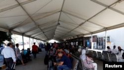 Libyan passengers wait at Mitiga airport in Tripoli, Libya August 24, 2019. REUTERS/Ismail Zitouny