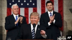 U.S. President Donald Trump, flanked by Vice President Mike Pence and House Speaker Paul Ryan of Wisconsin, gestures on Capitol Hill in Washington before his address to a joint session of Congress, Feb. 28, 2017.