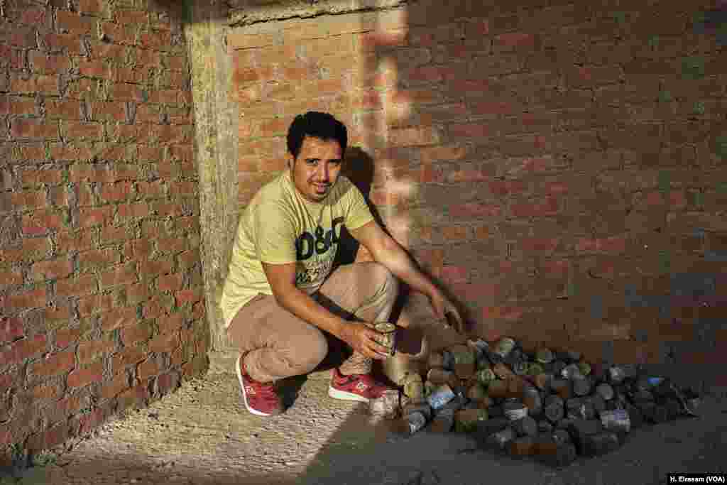 Musa Nazmy, a Garbage City resident, empties an expired can of beans that will be used in a biogas system that has been installed in his neighborhood. Biogas production is one way some people are starting to make use of food that would otherwise be wasted.