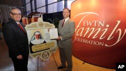 FILE - EWTN Global Catholic Network President and CEO Michael P. Warsaw, left, reacts with pleasure as Canton, Ohio Mayor William Healy, honors EWTN Foundress Mother Angelica.