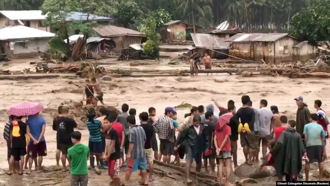 People help to rescue flood victims in Lanao Del Norte, Philippines, Dec. 22, 2017, in this image taken from video footage obtained from social media. Climah Cabugatan Disumala/via Reuters