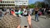 FILE - Counter-demonstrators and police officers gather at Gustav Adolfs Torg on the occasion of a public gathering where the organizer intends to burn a Koran, in Malmo, Sweden, May 3, 2024. (TT News Agency Johan Nilsson via Reuters) 