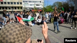 FILE - Counter-demonstrators and police officers gather at Gustav Adolfs Torg on the occasion of a public gathering where the organizer intends to burn a Koran, in Malmo, Sweden, May 3, 2024. (TT News Agency Johan Nilsson via Reuters) 