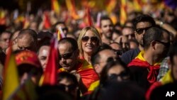 Activists march during a mass rally against Catalonia's declaration of independence, in Barcelona, Spain, Oct. 29, 2017. 