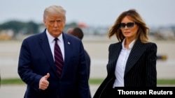 FILE PHOTO - U.S. President Donald Trump walks with first lady Melania Trump at Cleveland Hopkins International Airport in Cleveland