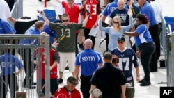 Football fans are screened by security 