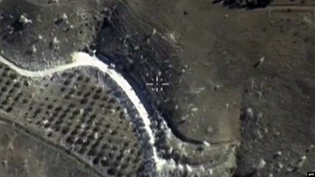 FILE - A video grab made on September 30, 2015, shows an image taken footage made available on the Russian Defense Ministry's official website, purporting to show an airstrike in Syria. 
