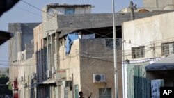 A rebel fighter walks in downtown Tripoli, Libya, August 23, 2011