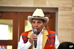 FILE - Donovan Archambault, from the Fort Belknap Indian Reservation, speaks about abuses he suffered at government-sponsored Native American boarding schools, during a U.S. Department of Interior event at Montana State University, Nov. 5, 2023, in Bozeman.