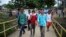 Men walk across a bridge inside the sports club where Central American migrants traveling with the annual Stations of the Cross caravan have been camped out, in Matias Romero, Oaxaca State, Mexico, April 4, 2018.