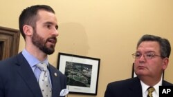 West Virginia Senate Majority Leader Ryan Ferns, R-Ohio, left, and House Education Chairman Paul Espinosa, R-Jefferson, discuss an agreement reached by a legislative conference committee for a 5 percent pay increase for striking teachers Tuesday, March 6, 2018, at the Capitol in Charleston, W.Va.