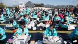 2026년 10월 9일 서울에서 열린 훈민정음 반포 580돌 기념 행사의 일환으로 전통 의상을 입은 어린이들이 한글 붓글씨 대회에 참가하고 있다.