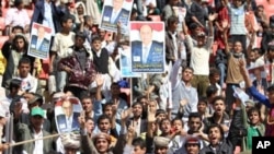 People carry posters of Yemen's Vice President Abed Rabbo Mansour Hadi during an election rally in Sana'a, February 20, 2012.