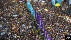 Protesters take part in a march on a street in Hong Kong, July 21, 2019.
