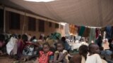 FILE - Children rest as people fleeing violence wait to be registered as displaced persons in a South Sudan Red Cross compound in Wau, South Sudan, July 1, 2016.