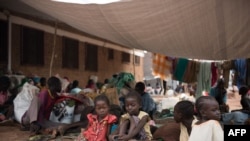 FILE - Children rest as people fleeing violence wait to be registered as displaced persons in a South Sudan Red Cross compound in Wau, South Sudan, July 1, 2016.