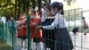 School children wash their hands to help curb the spread of the coronavirus before entering Kim Song Ju Primary School in Central District in Pyongyang, North Korea, Oct. 13, 2021.