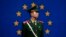 FILE - A Chinese policeman stands in front of the European Union flag outside the office of the European Union delegation to China in Beijing, Oct. 28, 2011. The chamber said the EU is unlikely to lift trade barriers this year because of fears Chinese exports are causing job losses.