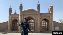 Seorang anggota pasukan Taliban berjaga di dekat lokasi ledakan di Kabul, Afghanistan, 4 Oktober 2021. (REUTERS/Staff)