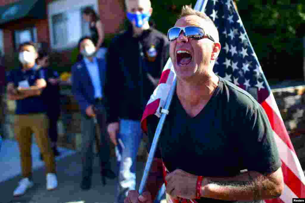 Michael Breitenbach, 47, screams at supporters of Democratic presidential nominee Joe Biden across the road after news media named Democratic presidential nominee Joe Biden the winner.