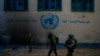 FILE - Israeli soldiers take position as they enter the UNRWA headquarter during a ground operation in Gaza, Thursday, Feb. 8, 2024.