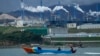 Perahu warga tampak melintasi perairan di dekat kawasan industri Weda Bay di Halmahera tengah, Maluku Utara, pada 8 Juni 2024. (Foto: AP/Achmad Ibrahim)