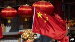 A national flag is seen outside a traditional medicine hospital in Beijing, China, March 3, 2020.