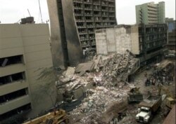 FILE - This Aug. 8, 1998, file photo shows the United States Embassy, left, and other damaged buildings in downtown Nairobi, Kenya, the day after terrorist bombs in Kenya and Dar es Salaam, Tanzania.