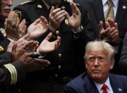 U.S. President Donald Trump listens to applause after signing an executive order on police reform during a ceremony in the Rose Garden at the White House in Washington, June 16, 2020.